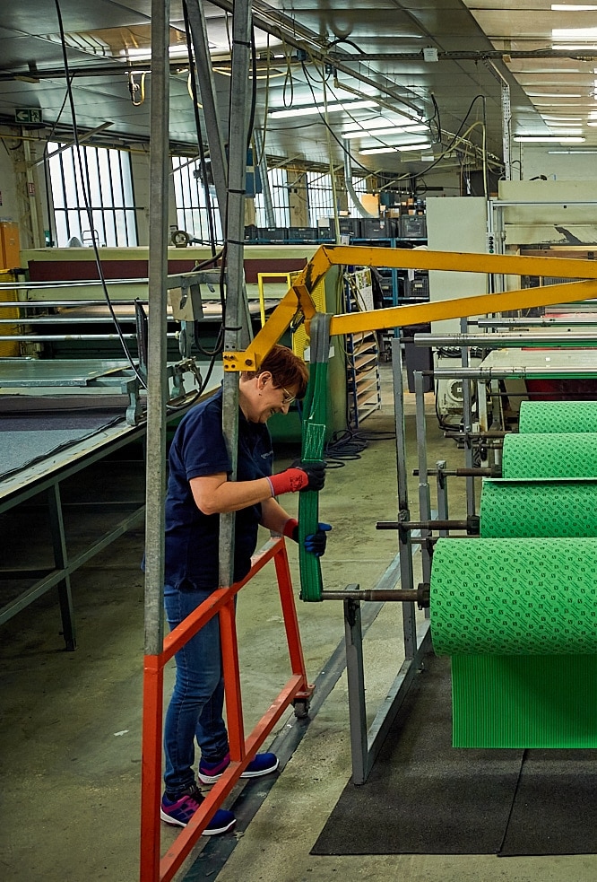 Someone loading a factory machine